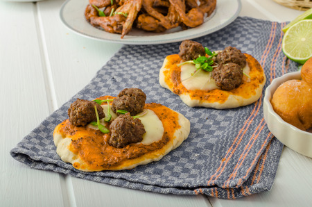 Chicken wings, vegetable, french fries, pizza, donuts, lime juice, dip, cucumber salad and toast.の写真素材