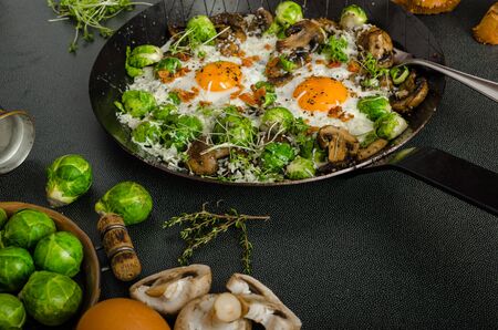 Vegetable omelet with bulls eye fried egg, mushrooms and Brussels sproutsの写真素材