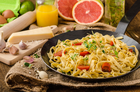 Semolina pasta with roasted garlic, sprinkled microherbs, fresh and tasty, garlic baked in the oven - deliciousの写真素材