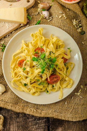 Semolina pasta with roasted garlic, sprinkled microherbs, fresh and tasty, garlic baked in the oven - deliciousの写真素材