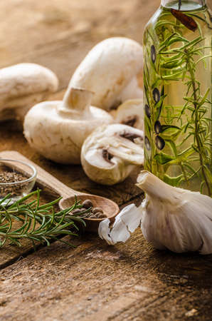 Bio garlic, spices and wild mushrooms from the home garden, olive oil, simple compositionの写真素材