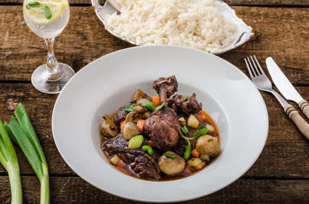 Chicken in red wine with vegetable and baked mushroomsの写真素材