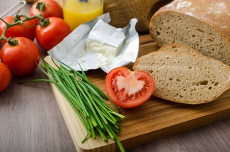 Healthy breakfast - homemade beer bread with cheese, tomatoes and chives