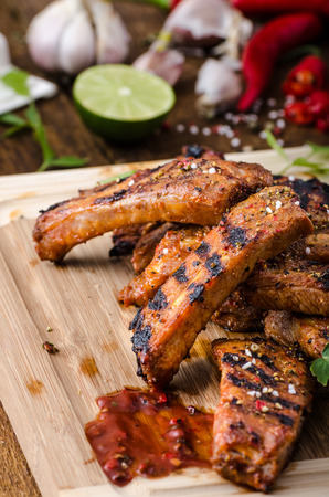 Ribs in spicy marinade with chilli, honey and beer. homemade rustic breadの写真素材