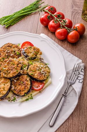 Fried zucchini breaded, with simple vegetable salad, sprinkled herbsの写真素材