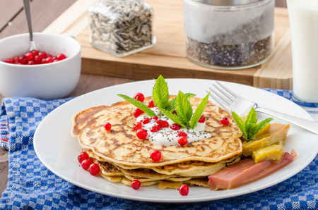 Homemade pancakes with cream, currant and baked rhubarb
