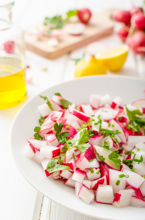 Radish Spring salad with herbs, fresh and delicious dressing from olive oil, pepper, salt and lemon juice and zestの写真素材
