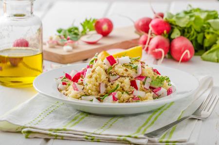 Couscous with radishes and herbs, topped herbs and olive oil, simple but delicious vegetarian foodの写真素材