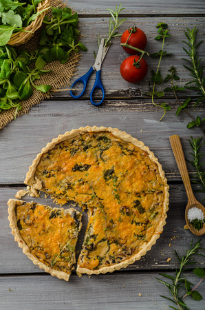 Domestic rustic quiche, filled onion herbs, garlic and salad.の写真素材