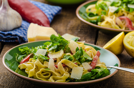 Tagliatelle with bacon, garlic and salad, homemade pasta from best italian flour - semolinaの写真素材