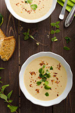 Creamy zucchini soup with chilli and oregano, crispy bread with garlicの写真素材