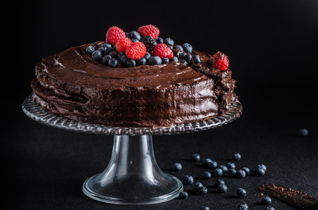 Three flour chocolate cake with berriesの写真素材