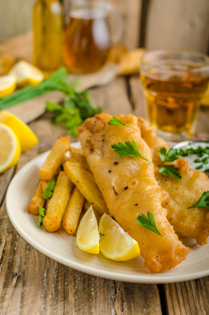 Fish and chips. Fish wrapped in beer batter, herbs dip and czech beerの写真素材
