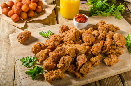 Delicious chicken popcorn, with hot tomato souce and potato croquettesの写真素材