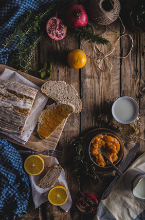 domestic bread spread with homemade bio apricot jamの写真素材