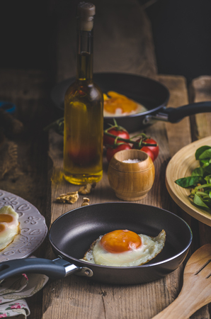 Fried eggs with salad and nuts, rustic photoの写真素材