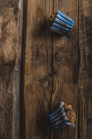 Whole grain muffins with dark chocolate and nuts, rustic styleの写真素材