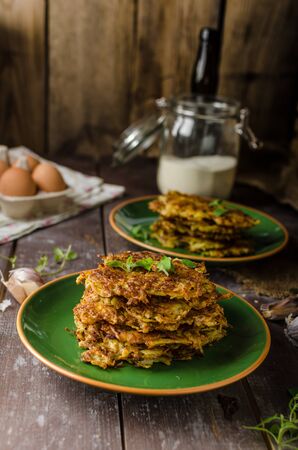 Potato pancakes with garlic and herbs, delicious czech beerの写真素材