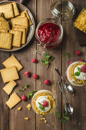 Inverted cheesecake dessert in glass, delicious and simple with fresh fruits and biscuit with light creame.の写真素材