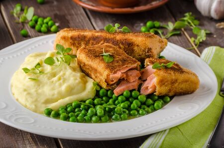 Fried salmon in herb crust with peas and mashedの写真素材