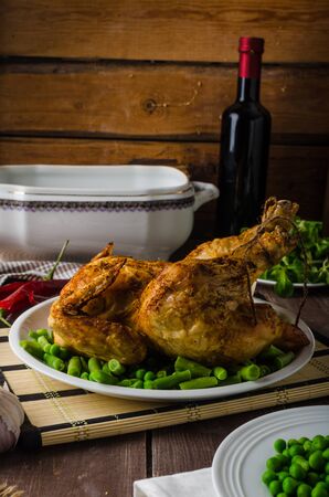 Feast - grilled chicken with potatoes, vegetables and wineの写真素材