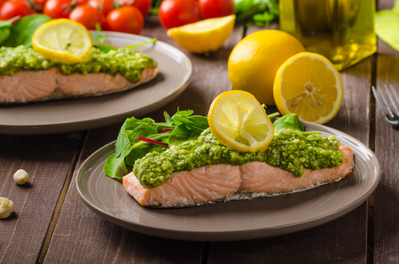 Baked salmon steamed with pesto and fresh saladの写真素材