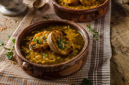 French onion soup rustic styled photo, with toasted bread and melted cheese on the topの写真素材