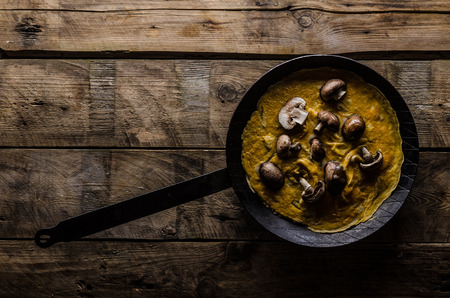 Omelette with forest mushrooms, rustic styled photo, place for advertising
