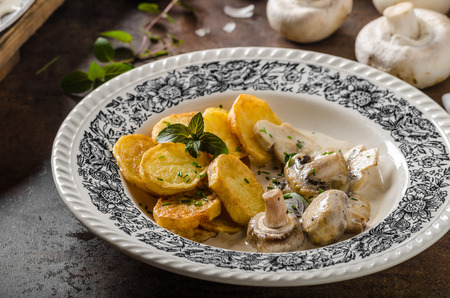 Mushroom sauce with roasted potatoes, lots of herbs for best flavourの写真素材