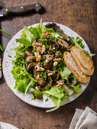 Mushroom salad with walnuts with baguette, lots of herbs insideの写真素材