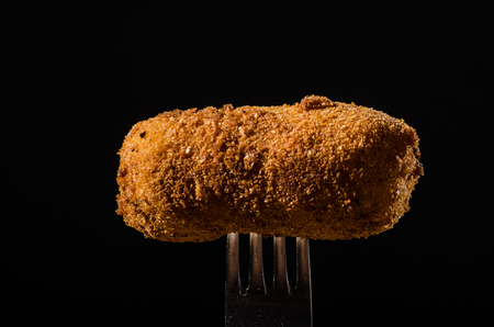 Homemade potato croquettes on black backgroundの写真素材