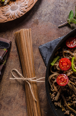 Whole grain pasta with cheese parmesan and tomatosの写真素材