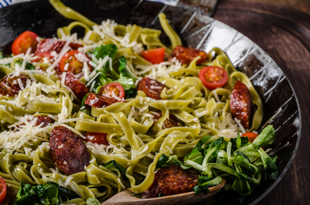 Pasta salad with sausage, topped with parmesan cheeseの写真素材