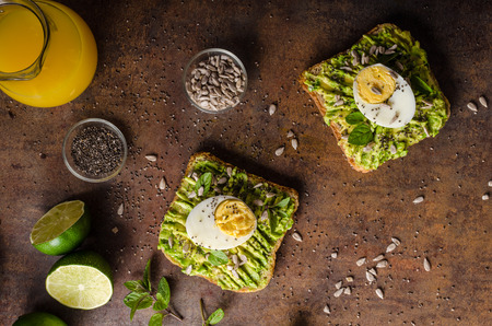Wholegrain sandwich healthy, full of bio seeds, avocado, herbs and egg