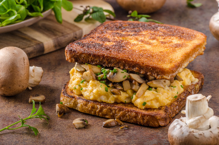 French toast scrambled eggs, fresh mushrooms and herbs inside, delicious and simple!の写真素材