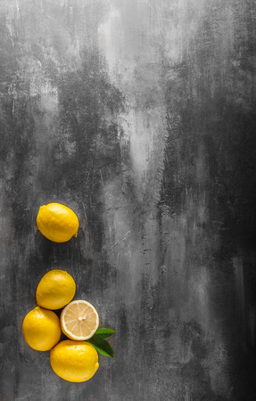 Fresh lemons photo, cutting board with chef knife, place for textの写真素材