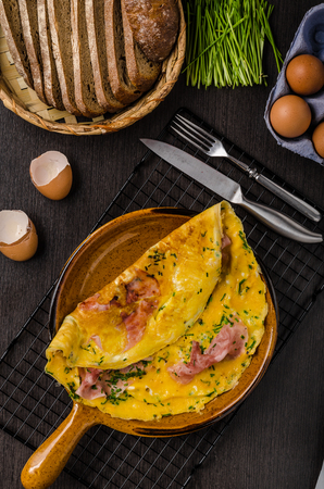 Ham and egg omelette, delicious and simple with fresh bread and herbs chiveの写真素材