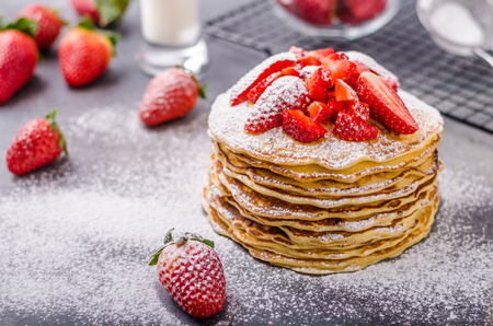 American pancakes with strawberries, topped with sugarの写真素材