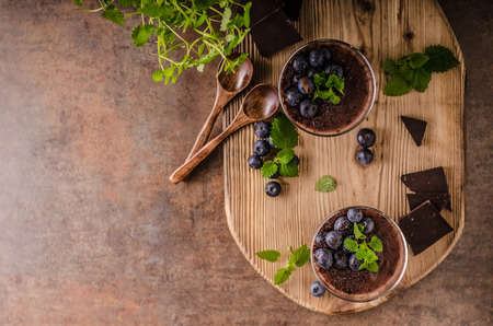 Chocolate pudding with berries and herbs, vintage rustic food styled picture, for your advertismentの写真素材