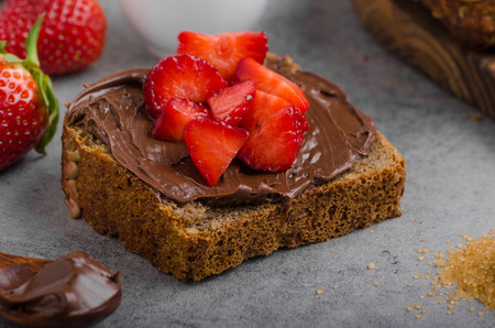 Nutella spread with wholegrain bread, fresh strawberriesの写真素材