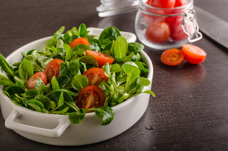 Lamb lettuce salad, tomatoes and herbs, food photographyの写真素材