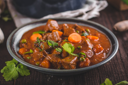Beef stew with carrots, food photography, lot of herbs inside stewの写真素材