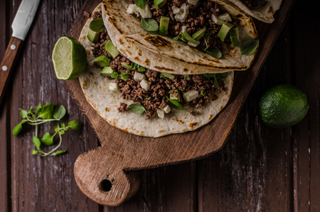 Homemade minced beef tortilla, fresh avocado and mozarella cheeseの写真素材