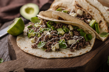 Homemade minced beef tortilla, fresh avocado and mozarella cheeseの写真素材