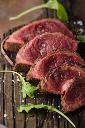 Homemade Beef Steak rare, pepper and salt and little saladの写真素材