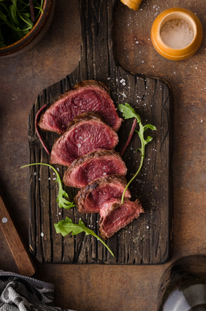 Homemade Beef Steak rare, pepper and salt and little saladの写真素材