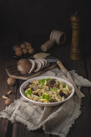 Homemade tortellini with mushrooms and walnuts, simple food photography with on vintage napkinの写真素材