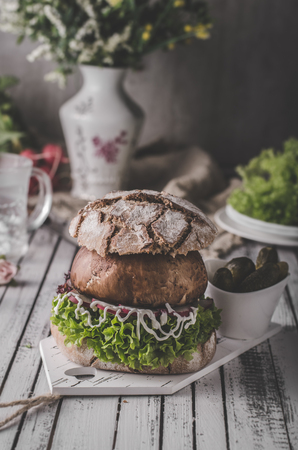 Portobello burger, homemade bun and lettuce, vegetarian burger with mayo and radishesの写真素材