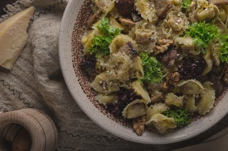 Homemade tortellini with mushrooms and walnuts, simple food photography with on vintage napkinの写真素材