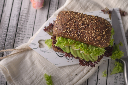 Homemade avocado lettuce sandwich, wholegrain bread, food photographyの写真素材
